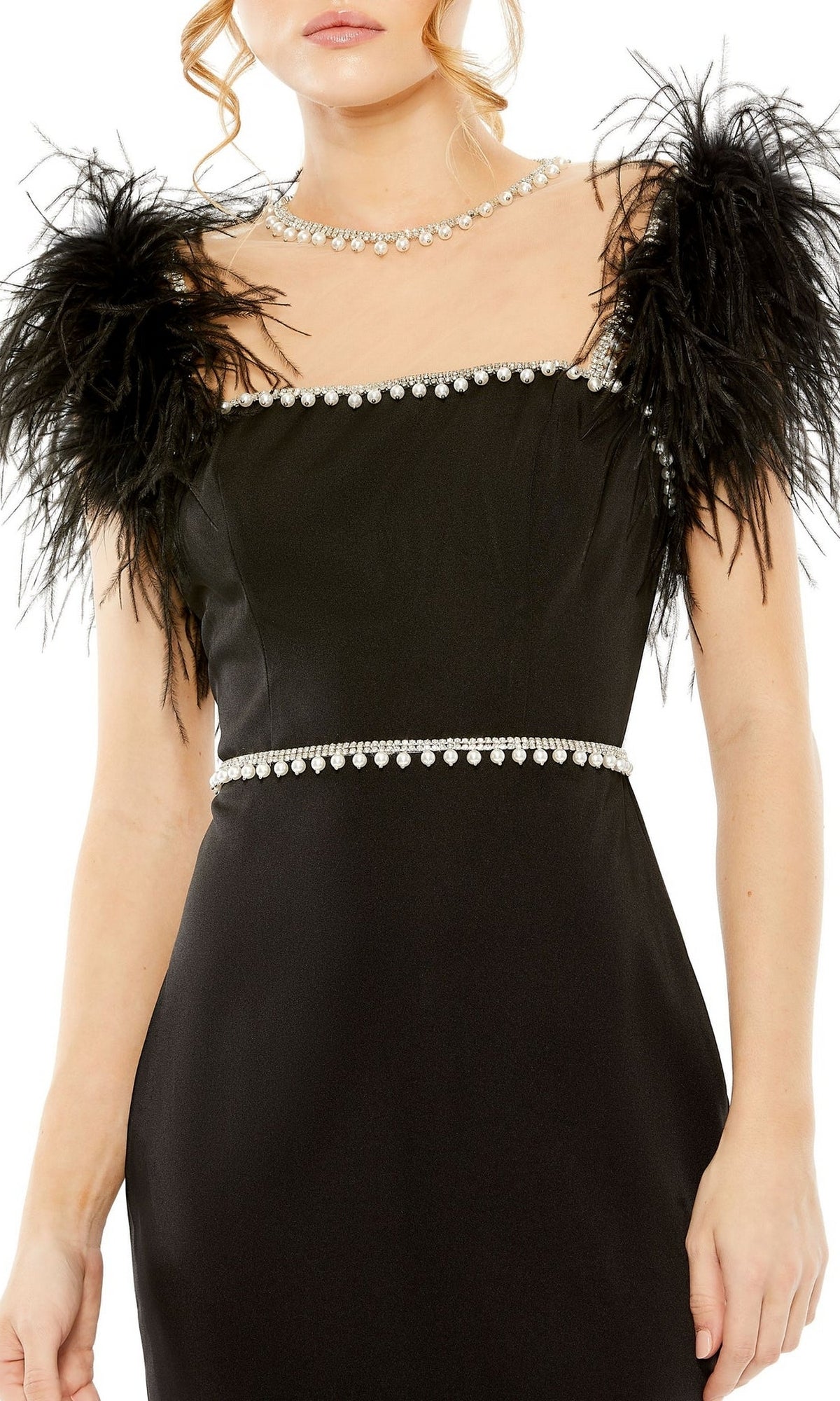 Woman wearing the Mac Duggal 11438 Sheer High-Neck Wedding-Guest Dress, featuring feathered shoulders and rhinestone trim, paired with a matching rhinestone necklace—a chic, knee-length choice for wedding guests.